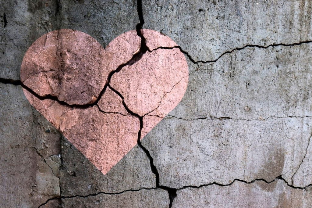 heart drawn on a wall with the wall breaking